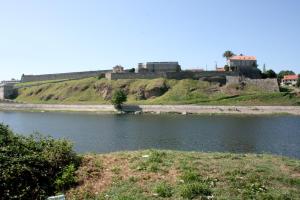 a castle on a hill next to a body of water at A Casa Do Viso Do Chirin in Ponteareas