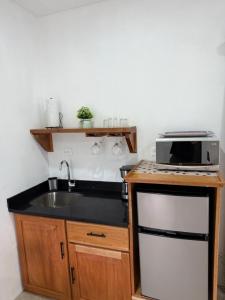 a kitchen with a sink and a microwave at Creekside Lofts #1 in Fortuna