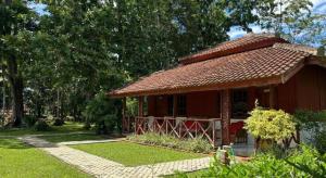 a small red building with a red roof at Satwa Elephant Eco Lodge in Labuhanratu