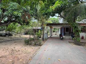 a motorcycle parked in front of a house at Chellams Churchview Homestay in Velankanni