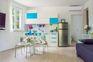 乌马格海上彭塔公寓的厨房里有一张桌子和一个冰箱