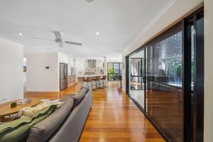 a living room with a couch and a table at Mountaintop Pool Retreat - The Ideal Family Escape in Buderim