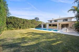 a house with a yard with a swimming pool at Mountaintop Pool Retreat - The Ideal Family Escape in Buderim