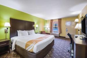 a hotel room with a large bed and a television at Quality Inn Fredericksburg-Central Park Area in Fredericksburg