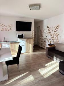 a living room with a table and a couch at Platinum Guesthouse in Szeged
