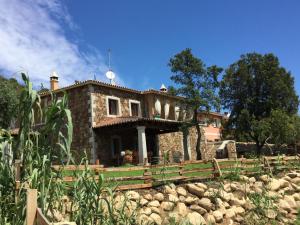 a stone house with a fence in front of it at Il giardino di Daniela in San Teodoro