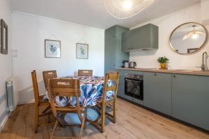 a kitchen and dining room with a table and chairs at La roche étoilée - Jacuzzi in Vienne