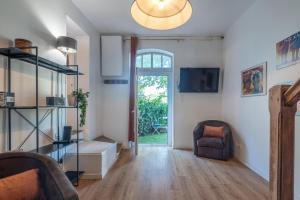 a living room with a couch and a chair at La roche étoilée - Jacuzzi in Vienne