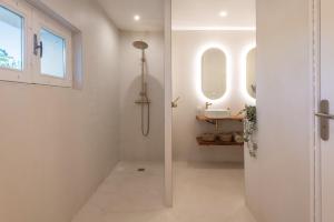 a bathroom with a shower and a sink at La roche étoilée - Jacuzzi in Vienne +20 photos