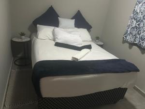 a bed with a book sitting on top of it at Gwendolen in Pretoria