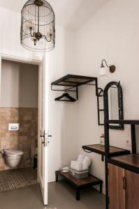 a bathroom with a toilet and a shelf at Sakula Hotel in Alaçatı