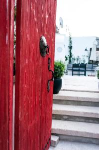 a red door with a lock on a set of stairs at Sakula Hotel in Alaçatı