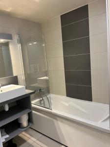 a bathroom with a shower and a sink and a tub at Agapanthe in Remoulins