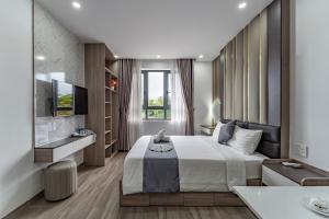 a bedroom with a large bed and a television at Seven Stars Hotel & Apartment in Vung Tau
