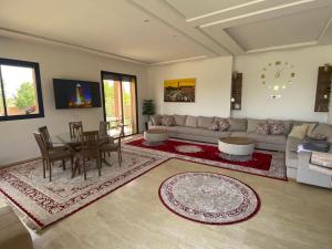 a living room with a couch and a table at Villa Dar Daraa with Pool in Najem
