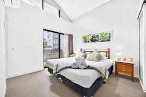 a bedroom with a large bed and a window at Cloud Nine City Centre 1BDR in Perth