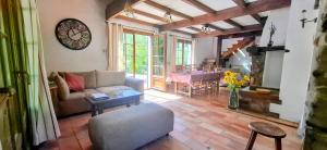 a living room with a couch and a table at Maison Provençale avec piscine in Estoublon