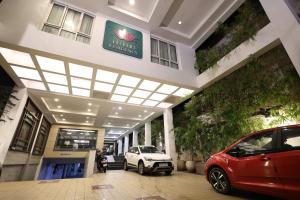 a car dealership with a car parked in front of it at Abirami Residency in Pondicherry