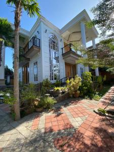 una casa con una palma di fronte di abneina pro homestay a Brassan