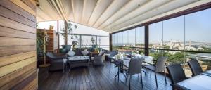 a restaurant with tables and chairs on a balcony at Burckin Hotel in Istanbul