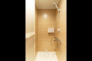a bathroom with a shower and a toilet at Koala Inn Ueno in Tokyo