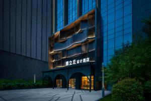 a building with a sign on the side of it at Delizzo Boutique Hotel Chengdu in Chengdu