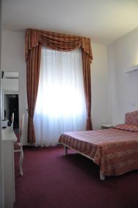 Postel nebo postele na pokoji v ubytování Hotel Sirena