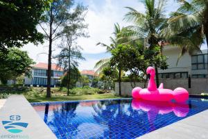 a pink swan float in a swimming pool at Esea43 private pool villas in Danang