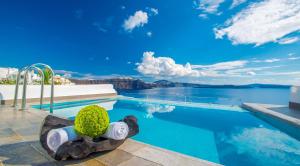 a resort swimming pool with a view of the water at Santorini Secret Suites & Spa, Small Luxury Hotels of the World in Oia
