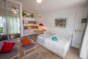 a bedroom with a bed and a table and chairs at Apartments Gardelin Superior in Zadar +37 photos