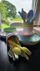 a pile of plates with utensils on a table at O'Blanche, Viroinval Treignes in Treignes