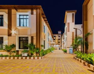 an empty street in an apartment complex at night at Hotel Grand Heritage Badami in Badami