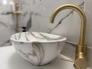 a bathroom sink with a bowl and a faucet at Appartement atypique chaleureux in Rosières-devant-Bar +6 photos