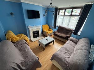 a living room with a couch and a fireplace at 4 Bedroom Central Birmingham in Birmingham