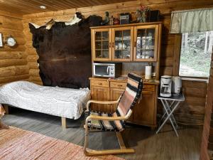 a bedroom with a bed and a desk and a chair at Seiväslahti in Keuruu