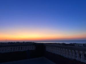 a view of the sunset from the balcony of a building at بيت العز للشقق الفندقية - علم الروم Bet Elezz Apartments-Alam Elrom in Marsa Matruh