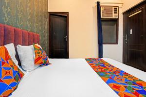 Ένα ή περισσότερα κρεβάτια σε δωμάτιο στο FabHotel Insight Inn