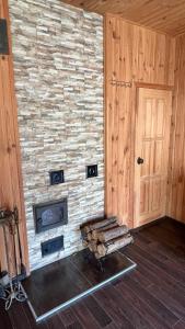 a room with a stone wall with a fireplace and a door at House on Fontan in Odesa +18 photos