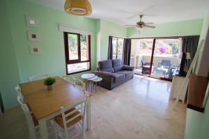 a living room with a table and a couch at Burriana Beach Apartment in Nerja