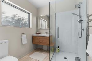 a bathroom with a shower and a sink at Seaview - Mangawhai Heads Holiday Home in Mangawhai +26 photos