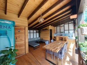 a dining room with a wooden table and chairs at Casa David in Gura Hangului