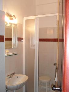 a bathroom with a sink and a shower at Hotel Olympion in Katerini