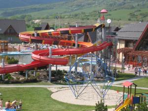 a water slide in a park with a water park at Apartmán Paradise in Bešeňová