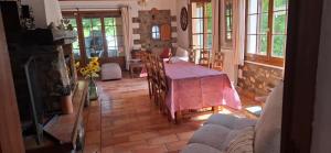 a living room with a table and a couch at Maison Provençale avec piscine in Estoublon