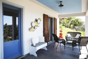 a porch with chairs and a table and a window at Appartamento Magdalena in Cannero Riviera