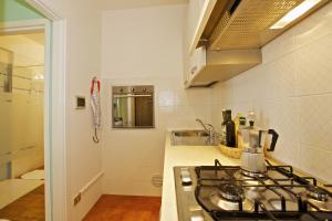 a small kitchen with a stove and a sink at Appartamento Magdalena in Cannero Riviera +80 photos