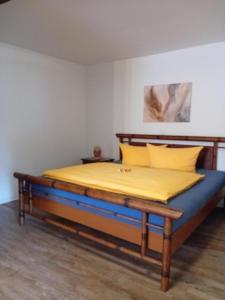 a bed in a room with a yellow mattress at Moselblick Hotel Aroma Bikershouse in Burgen