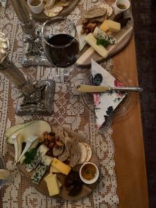 a table topped with plates of cheese and bread at Wiisalan Kartano in Savonlinna +32 photos
