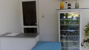 a room with a refrigerator filled with lots of bottles at Lurd Family Hotel in Lozenets