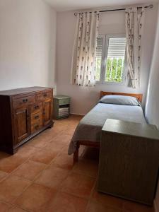 a bedroom with two beds and a dresser and a window at Casa Bueno- Sleeps 7 Private Pool & AirCon in Los Llanos +49 photos